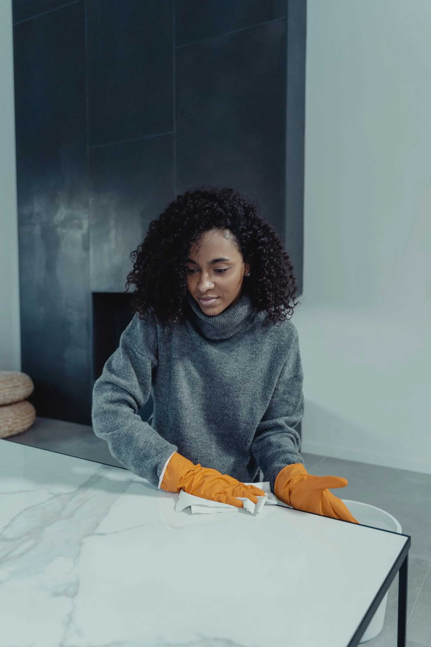 Cleaner wearing gloves wiping a marble surface. — illustrative photograph.